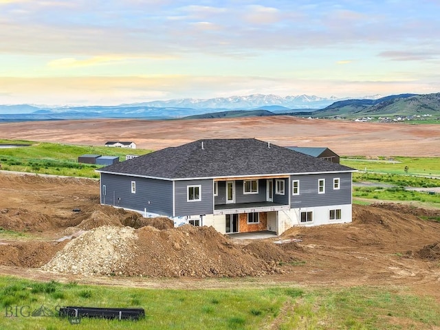 20 Hollow Top Trl, Three Forks, MT 59752 - view of front facade featuring a mountain view, a shingled roof, and a patio area