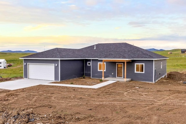 20 Hollow Top Trl, Three Forks, MT 59752 - ranch-style home featuring a garage, concrete driveway, a shingled roof, and covered porch