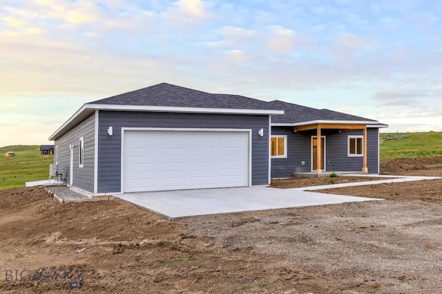 20 Hollow Top Trl, Three Forks, MT 59752 - ranch-style home with concrete driveway, a garage, and roof with shingles