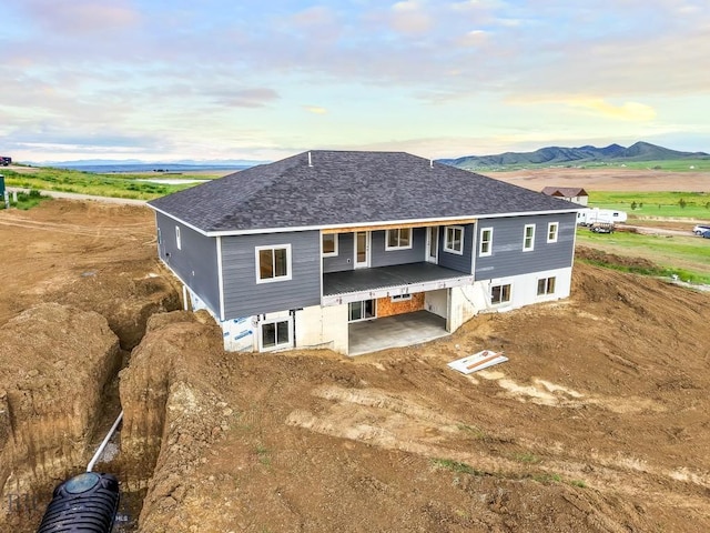 20 Hollow Top Trl, Three Forks, MT 59752 - rear view of property with a patio area, a shingled roof, and an attached garage