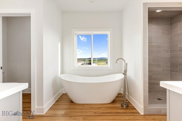 20 Hollow Top Trl, Three Forks, MT 59752 - full bath featuring a freestanding tub, tiled shower, wood finished floors, vanity, and recessed lighting
