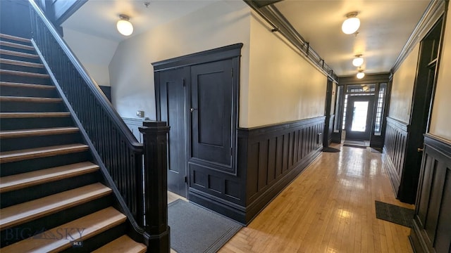 101 W Quartz Unit 1A, Butte, MT 59701 - foyer entrance with wainscoting, stairs, a decorative wall, and light wood-style floors