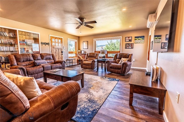 14 Peters Ln, Gardiner, MT 59030 - living area featuring a wall mounted air conditioner, ceiling fan, dark wood-style flooring, and a textured ceiling