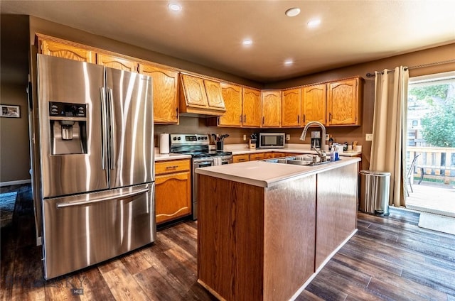 14 Peters Ln, Gardiner, MT 59030 - kitchen featuring appliances with stainless steel finishes, light countertops, dark wood-style flooring, a kitchen island with sink, and recessed lighting