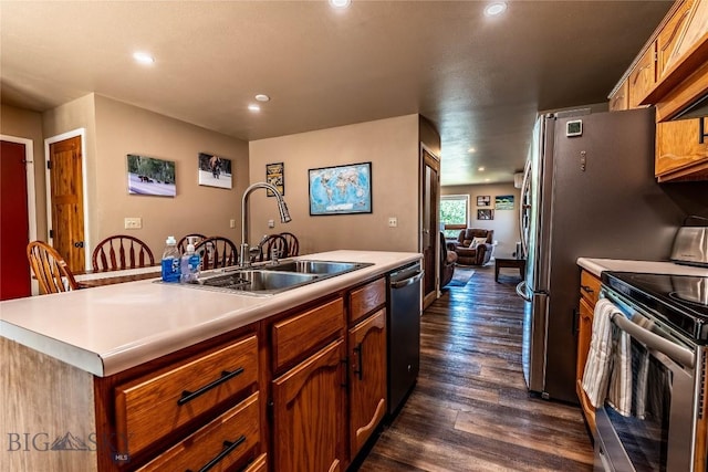 14 Peters Ln, Gardiner, MT 59030 - kitchen featuring stainless steel appliances, light countertops, recessed lighting, dark wood-style flooring, and a kitchen island with sink