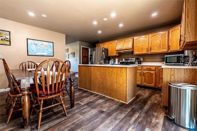 14 Peters Ln, Gardiner, MT 59030 - kitchen featuring stainless steel appliances, dark wood finished floors, light countertops, recessed lighting, and brown cabinets