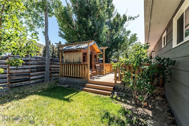 14 Peters Ln, Gardiner, MT 59030 - fenced backyard with a deck and a storage shed