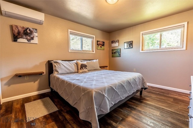 14 Peters Ln, Gardiner, MT 59030 - bedroom with a wall mounted air conditioner, multiple windows, and wood finished floors