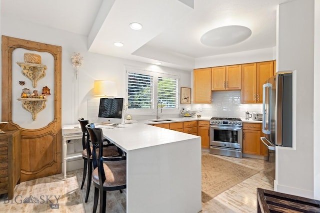 1037 Boylan Rd Unit 1, Bozeman, MT 59715 - kitchen featuring stainless steel appliances, a breakfast bar area, a peninsula, light countertops, and decorative backsplash