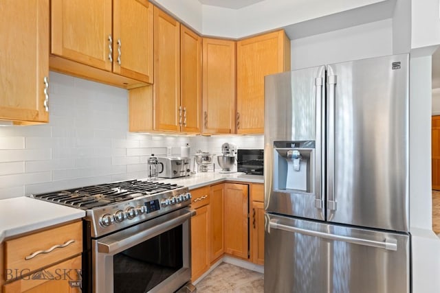 1037 Boylan Rd Unit 1, Bozeman, MT 59715 - kitchen featuring stainless steel appliances, light countertops, and decorative backsplash