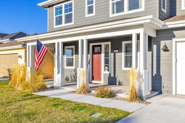 1606 Wyatt Earp Ct, Belgrade, MT 59714 - doorway to property with a garage, covered porch, and concrete driveway