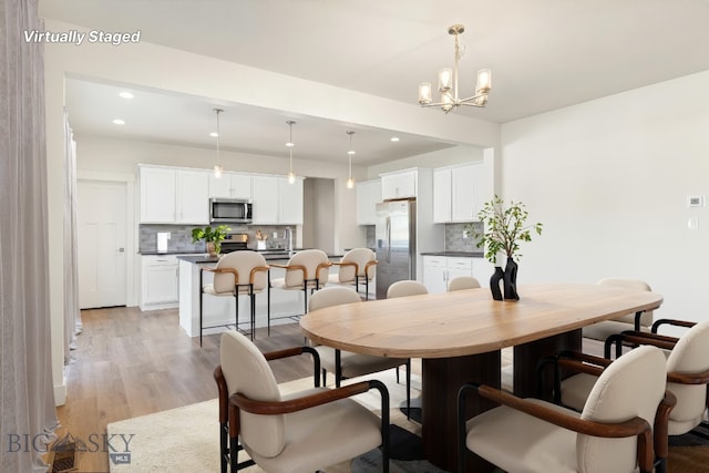 1606 Wyatt Earp Ct, Belgrade, MT 59714 - dining room featuring light wood-type flooring, recessed lighting, and a chandelier
