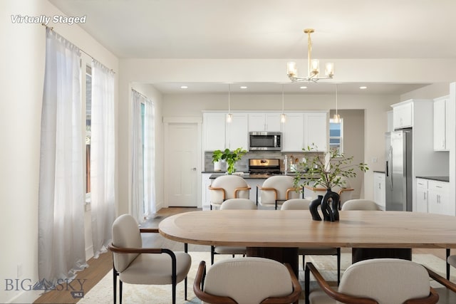 1606 Wyatt Earp Ct, Belgrade, MT 59714 - dining space with light wood-style flooring, a chandelier, and recessed lighting