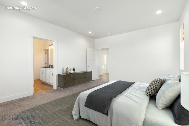 1606 Wyatt Earp Ct, Belgrade, MT 59714 - bedroom with light colored carpet, recessed lighting, and ensuite bathroom