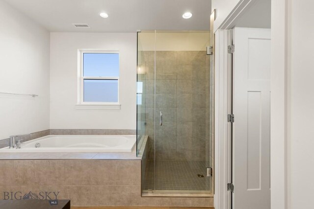 1606 Wyatt Earp Ct, Belgrade, MT 59714 - full bath featuring a bath, a stall shower, and recessed lighting