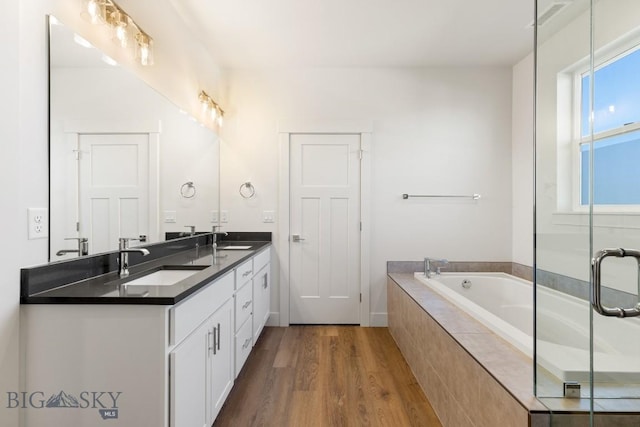 1606 Wyatt Earp Ct, Belgrade, MT 59714 - full bath with wood finished floors, double vanity, and a garden tub
