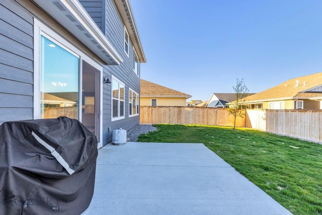 1606 Wyatt Earp Ct, Belgrade, MT 59714 - fenced backyard featuring a patio area and a grill