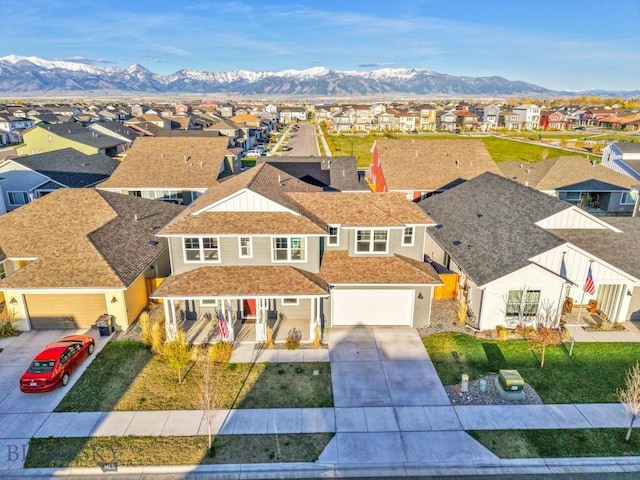 1606 Wyatt Earp Ct, Belgrade, MT 59714 - view of front facade featuring a residential view, driveway, a mountain view, and an attached garage