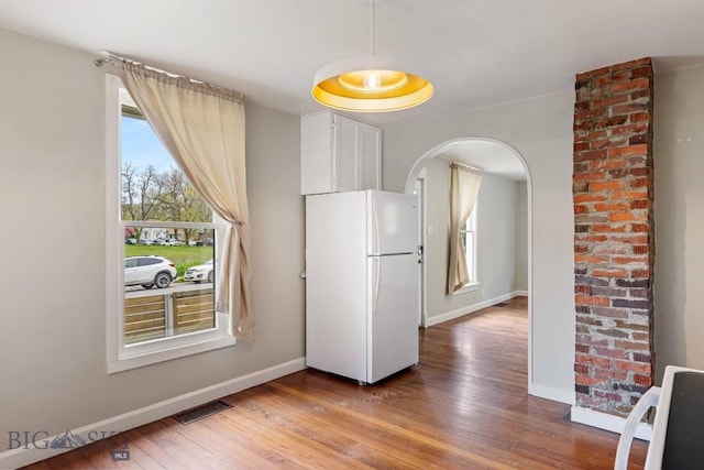 209 N 3rd Ave, Bozeman, MT 59715 - dining space with arched walkways and light wood-style flooring