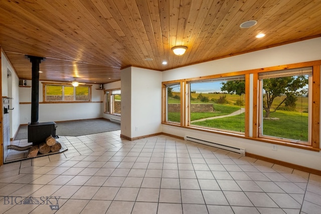 181 Pheasant Ln, Belgrade, MT 59714 - unfurnished living room featuring a baseboard radiator, wood ceiling, a wood stove, light tile patterned flooring, and recessed lighting