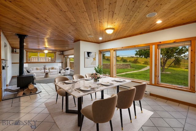 181 Pheasant Ln, Belgrade, MT 59714 - dining area featuring a wood stove, wooden ceiling, light tile patterned floors, plenty of natural light, and recessed lighting
