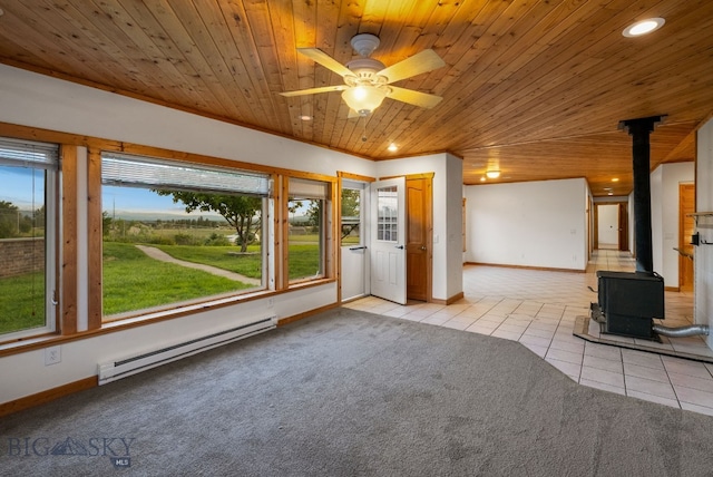 181 Pheasant Ln, Belgrade, MT 59714 - unfurnished living room with a baseboard heating unit, a wood stove, plenty of natural light, light tile patterned floors, and wooden ceiling