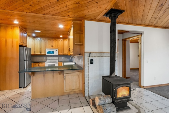 181 Pheasant Ln, Belgrade, MT 59714 - kitchen with white appliances, a wood stove, wooden ceiling, open shelves, and a peninsula