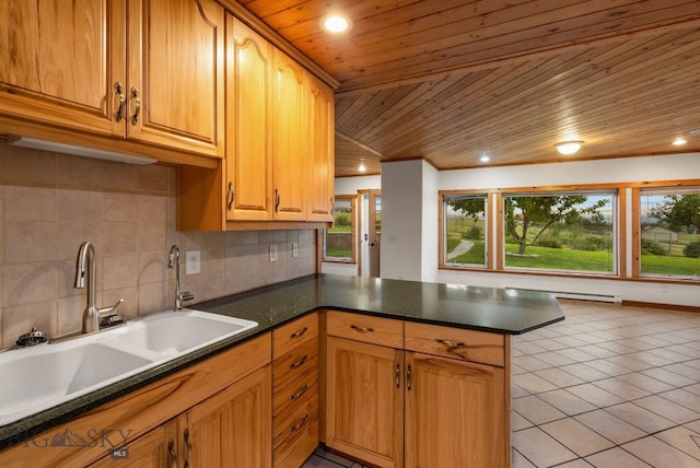 181 Pheasant Ln, Belgrade, MT 59714 - kitchen featuring wooden ceiling, a peninsula, backsplash, light tile patterned floors, and dark countertops