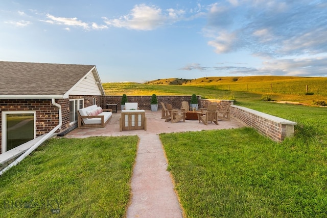 181 Pheasant Ln, Belgrade, MT 59714 - view of green lawn with a patio area and an outdoor fire pit