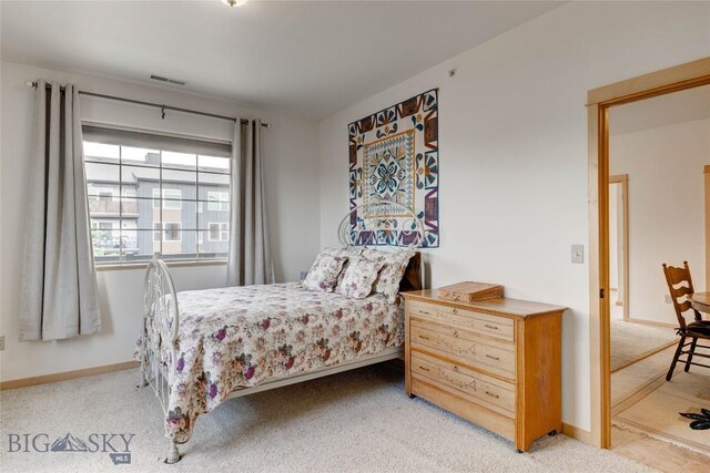 2221 Willow Unit 201-B, Livingston, MT 59047 - bedroom featuring light carpet and baseboards