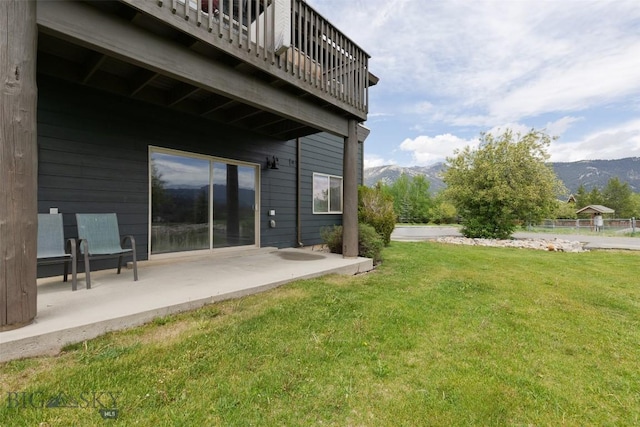 120 Firelight Dr Unit C10, Big Sky, MT 59716 - view of grassy yard with a patio, a mountain view, and a balcony