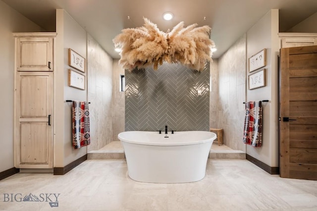 16 Tight Loop Dr, Bozeman, MT 59718 - bathroom featuring a freestanding tub and baseboards
