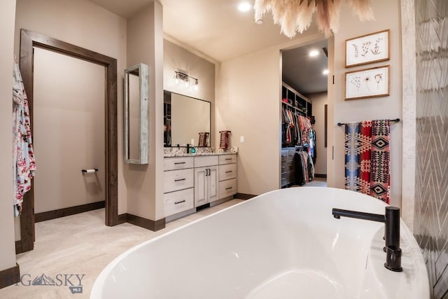 16 Tight Loop Dr, Bozeman, MT 59718 - full bathroom featuring a soaking tub, vanity, and a spacious closet