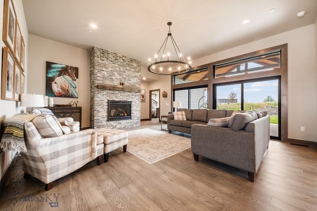 16 Tight Loop Dr, Bozeman, MT 59718 - living area with wood finished floors, a chandelier, a brick fireplace, and recessed lighting