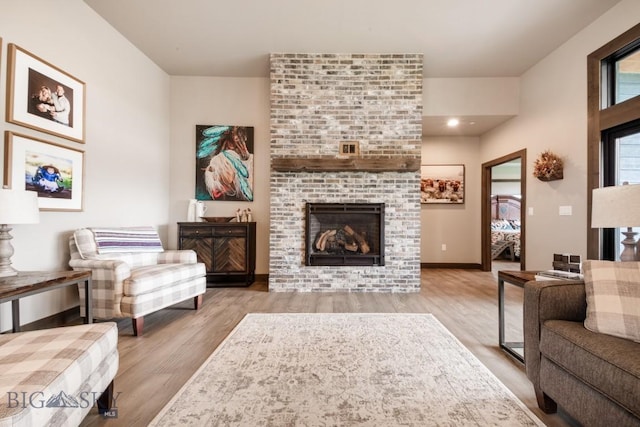 16 Tight Loop Dr, Bozeman, MT 59718 - living area featuring a brick fireplace and wood finished floors