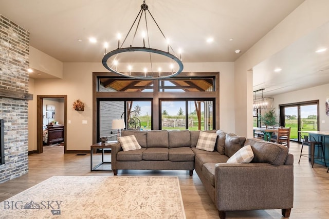 16 Tight Loop Dr, Bozeman, MT 59718 - living area featuring a chandelier, light wood-style floors, recessed lighting, and a fireplace
