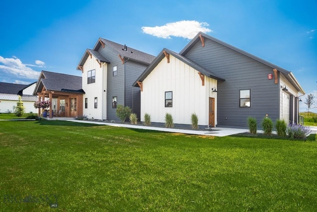 16 Tight Loop Dr, Bozeman, MT 59718 - rear view of house featuring board and batten siding, a garage, and a lawn