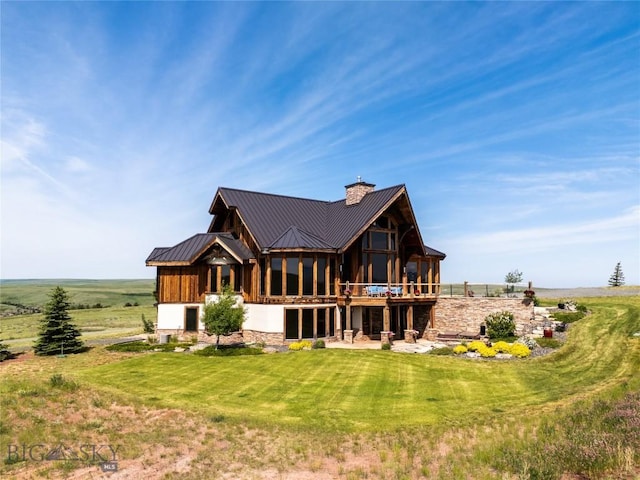 155 Peacemaker Ridge Rd, Belt, MT 59412 - rear view of property featuring a chimney, a metal roof, a lawn, and a deck