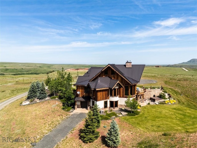 155 Peacemaker Ridge Rd, Belt, MT 59412 - view of front of property featuring a chimney, a standing seam roof, a metal roof, driveway, and a view of rural / pastoral area