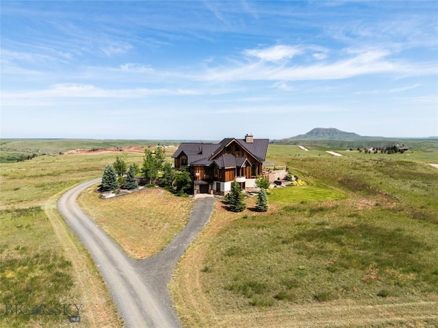 155 Peacemaker Ridge Rd, Belt, MT 59412 - view of front of house featuring driveway, a metal roof, a rural view, a chimney, and a mountain view