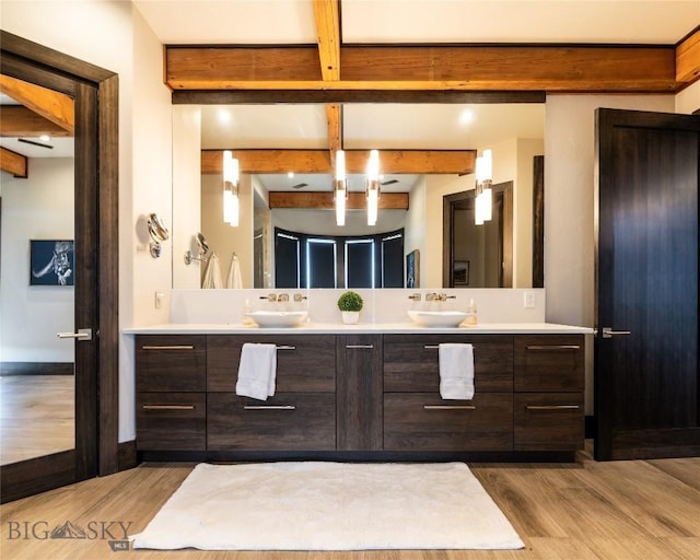 155 Peacemaker Ridge Rd, Belt, MT 59412 - bathroom featuring beam ceiling, wood finished floors, and double vanity