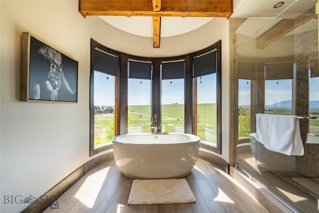 155 Peacemaker Ridge Rd, Belt, MT 59412 - bathroom featuring a freestanding tub, a stall shower, wood finished floors, and beam ceiling