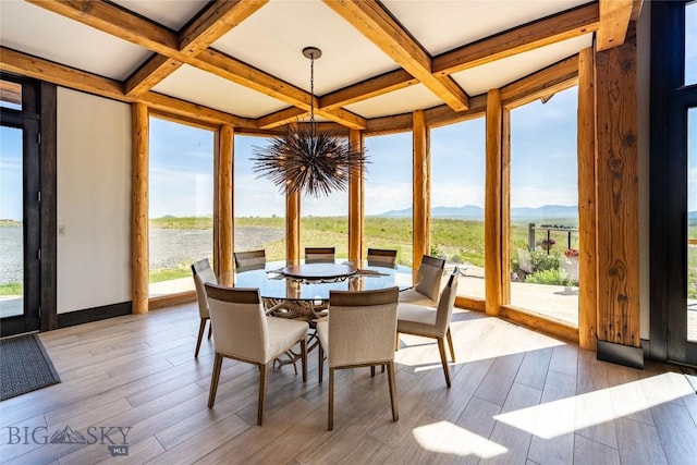 155 Peacemaker Ridge Rd, Belt, MT 59412 - sunroom with a chandelier, coffered ceiling, beam ceiling, wood finished floors, and a water and mountain view