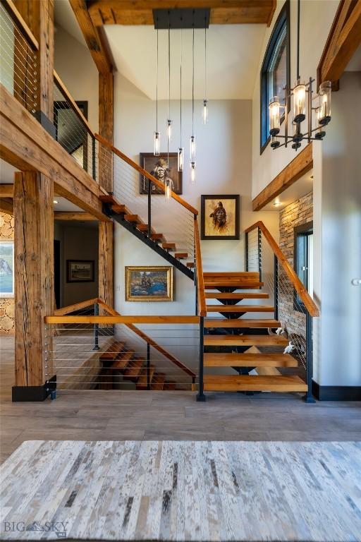 155 Peacemaker Ridge Rd, Belt, MT 59412 - staircase featuring a high ceiling, wood finished floors, and beamed ceiling