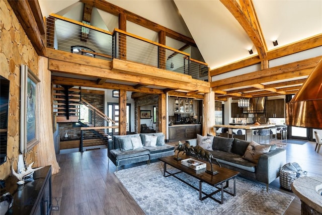 155 Peacemaker Ridge Rd, Belt, MT 59412 - living area featuring high vaulted ceiling, beam ceiling, stairs, and dark wood-style flooring