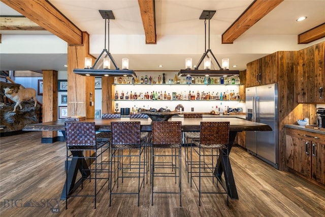 155 Peacemaker Ridge Rd, Belt, MT 59412 - indoor bar featuring freestanding refrigerator, beam ceiling, dark wood-style flooring, and hanging light fixtures
