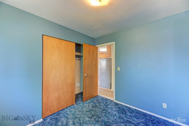 425 Russell, Helena, MT 59602 - unfurnished bedroom with dark colored carpet, a closet, and freestanding refrigerator