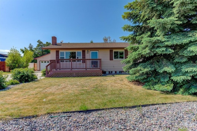425 Russell, Helena, MT 59602 - back of property with a wooden deck, a chimney, a lawn, and an attached garage