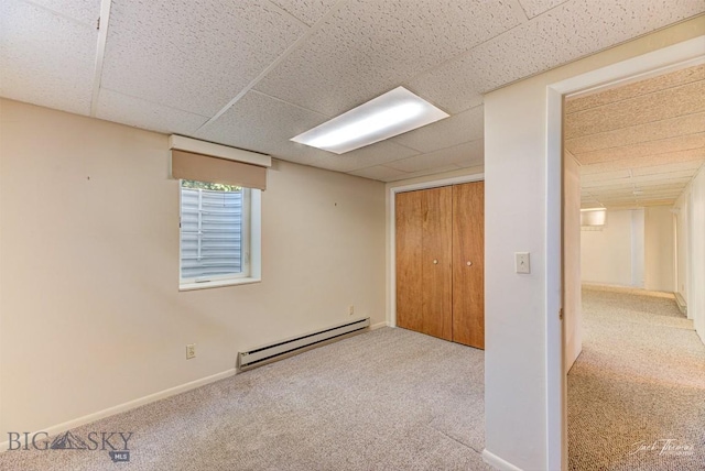 425 Russell, Helena, MT 59602 - unfurnished bedroom featuring a baseboard radiator, a drop ceiling, carpet floors, and a closet