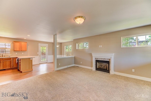 9 Sand Piper, Helena, MT 59602 - unfurnished living room with light colored carpet, a fireplace, and recessed lighting